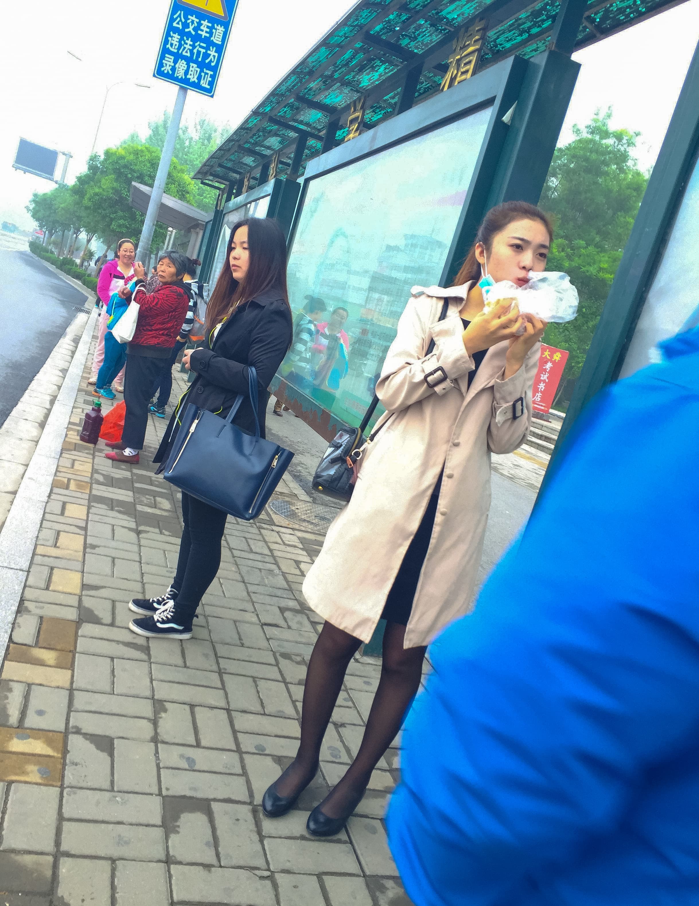 Crossed stockinged legs at stop